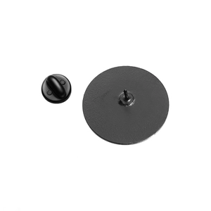 Detail showing the matte black metal brooch back with rubber pin clutch and needle