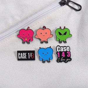 Set of 6 K-pop CASE 143 enamel pins featuring cartoon hearts and icons on a white bag