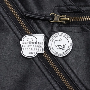Macro detail of survival 2020 toilet paper pins on black leather jacket texture