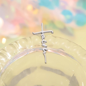 Polished silver faith cross pendant necklace for women on a soft bokeh background