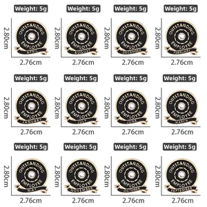 Matrix display of 12 circular outstanding employee enamel pins with monthly letters and gold rim