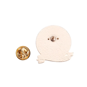 Macro detail of the matte gold metal back and butterfly clutch closure for enamel pins