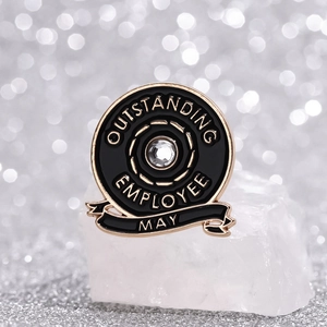 Gold-tone Outstanding Employee May badge with black enamel and crystal centerpiece