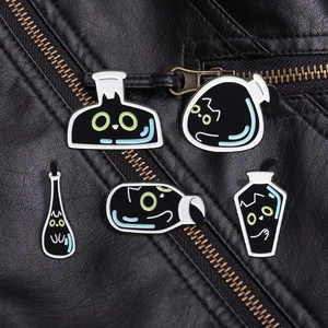 Detailed close-up of 5-piece black cat enamel pins on a leather jacket zipper