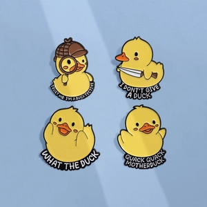 Set of four creative yellow duck enamel pins with humorous puns on a blue background