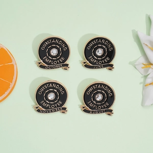 Round Outstanding Employee enamel brooch pins with gold trim and crystal set on green background
