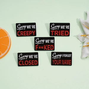 Set of five rectangle enamel pins with Sorry We Are quotes on light green background