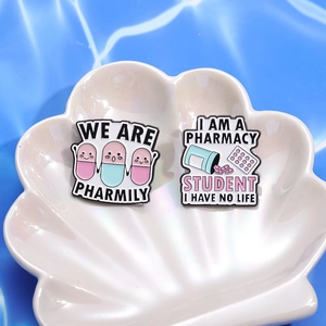 Cartoon enamel pharmacy pins featuring colorful pill characters and humorous medical slogans