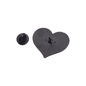 Detailed back view of a heart-shaped brooch with secure black rubber clutch fastener