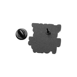 Detail view of enamel pin back showing matte black finish and rubber clutch fastener
