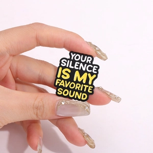 Inspirational enamel brooch with Your Silence Is My Favorite Sound text in black and yellow