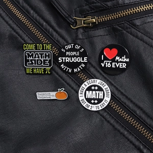 Close-up of five enamel math-themed pins on a black leather jacket showing geeky formulas
