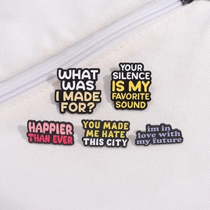 Five-piece colorful enamel pin set with motivational English quotes on white canvas background