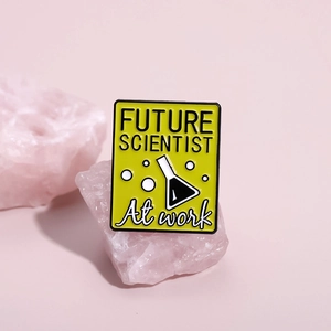 Cartoon future scientist enamel pin with chemistry flask on pink decorative crystal stones