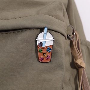 Detail of Adobe software icon bubble tea enamel pin on a dark green canvas backpack