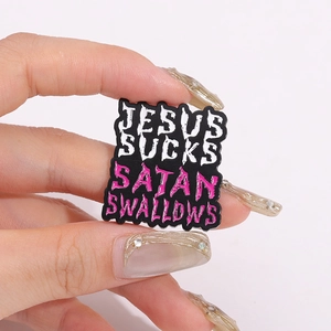 Punk style Jesus Sucks enamel pin badge featuring bold text on black background
