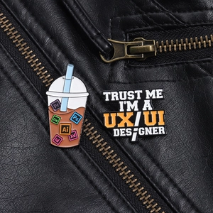 Close-up of milk tea badge with Adobe icons and UX/UI Designer enamel pin on jacket