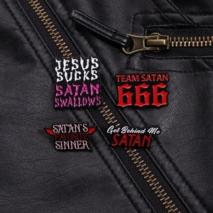 Gothic enamel pin set with Satanic slogans displayed on a black leather jacket