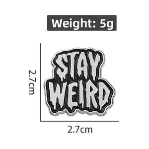Detail view of Stay Weird enamel pin badge with 2.7cm size dimensions and 5g weight specs