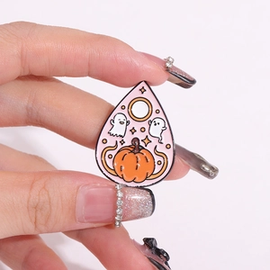 Halloween enamel pin with white ghosts and orange pumpkin on waterdrop-shaped metal base