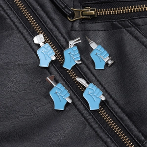 Set of five blue medical enamel brooches featuring surgical tools on a black leather jacket