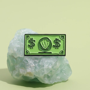 Creative green dollar bill enamel pin featuring currency symbols in pop art style
