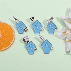5-piece medical enamel pin set with blue fists holding syringes and surgical tools