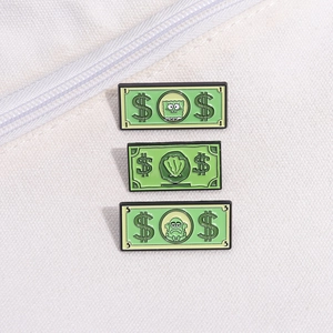 Macro shot of green dollar bill enamel pins with cartoon characters on white canvas