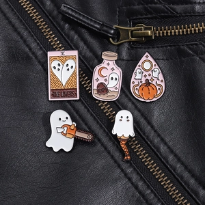 Close-up of five Halloween ghost enamel pins on a black leather jacket background