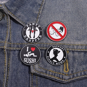 Detailed macro view of humorous enamel lapel pins set on a denim jacket background