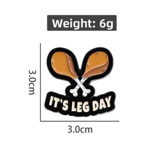 Detail view of cartoon enamel pin with 'IT'S LEG DAY' text and dimensions 3.0cm x 3.0cm
