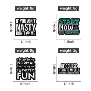 Detailed view of four black and white enamel badges with sizes and weight markers