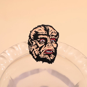 Retro horror werewolf enamel brooch made of alloy and lacquer on pink background