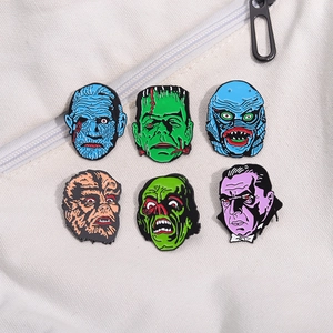Universal classic horror movie monster enamel pins set on a white canvas backpack