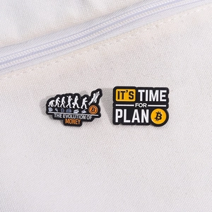 Creative black enamel pins with Bitcoin logo and The Evolution of Money slogan