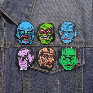 Classic horror movie monster enamel pins set displayed on a denim jacket pocket