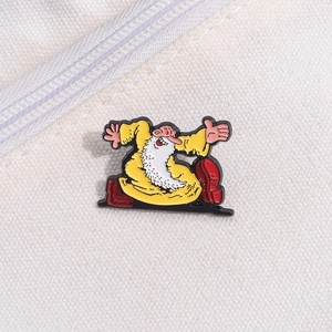 Macro shot of a cartoon old man enamel pin on canvas with vibrant yellow and red colors