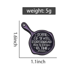 Détail du pin's émaillé en forme de poêle violette avec citation et dimensions