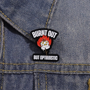 Funny enamel marshmallow pin Burnt Out But Optimistic on denim jacket lapel