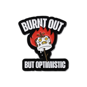 Burnt marshmallow enamel pin with burnt out but optimistic text on white background