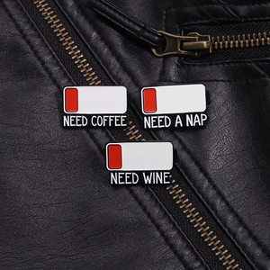 Detailed close-up of battery level enamel pins pinned to a black leather jacket texture