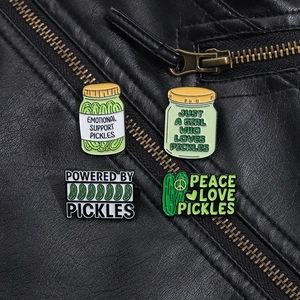 Detailed view of creative pickle enamel pins set pinned on a black leather jacket