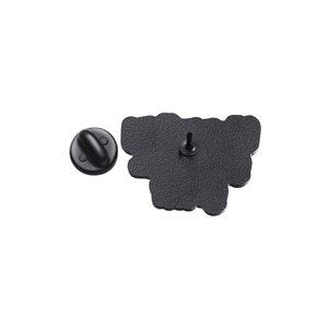 Detail view of the metal brooch back with irregular shape and black rubber clutch back