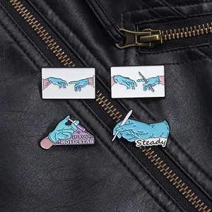 Detailed view of medical enamel pins set featuring scalpel and syringe on leather jacket