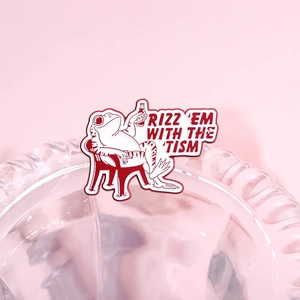 Funny cartoon frog enamel pin featuring 'RIZZ 'EM WITH THE 'TISM' slogan on pink background