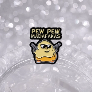 Cartoon yellow chicken enamel pin with sunglasses and gun featuring Pew Pew text