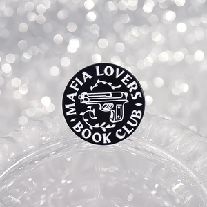 Round Mafia Lovers Book Club enamel pin with gun and vine details in black and white