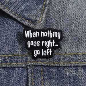Funny enamel brooch badge with inspirational quote on blue denim jacket texture
