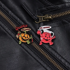 Detail of horror pumpkin ghoul and red cartoon enamel pins on black leather jacket