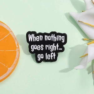 Black enamel cloud pin with When nothing goes right go left funny quote design